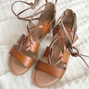 Faux leather ankle wrap gladiator sandals.